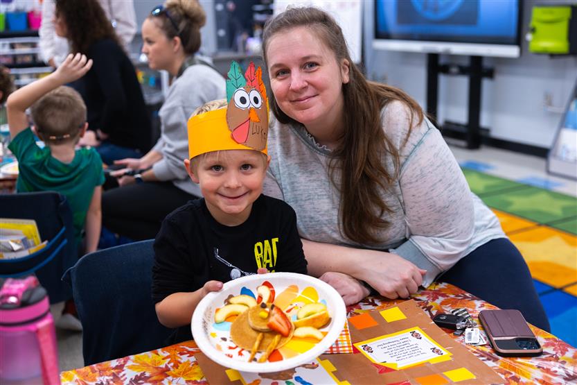 Creekside kindergartners and their families enjoy breakfast